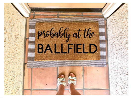 Probably at the ball field, baseball doormat, summer doormat